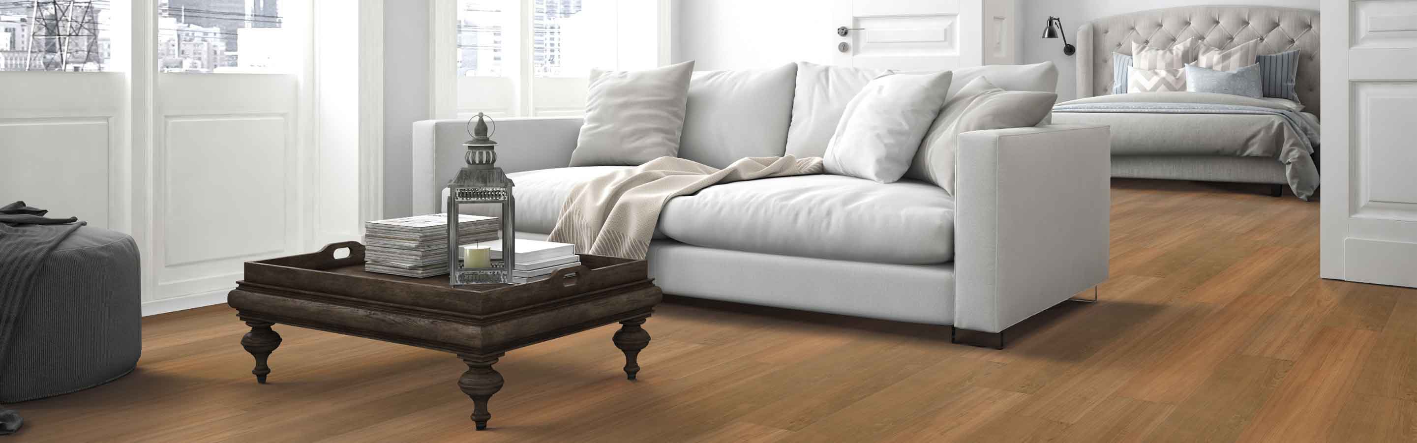 light wood-look vinyl in living room open concept apartment with wood coffee table and neutral furnishings