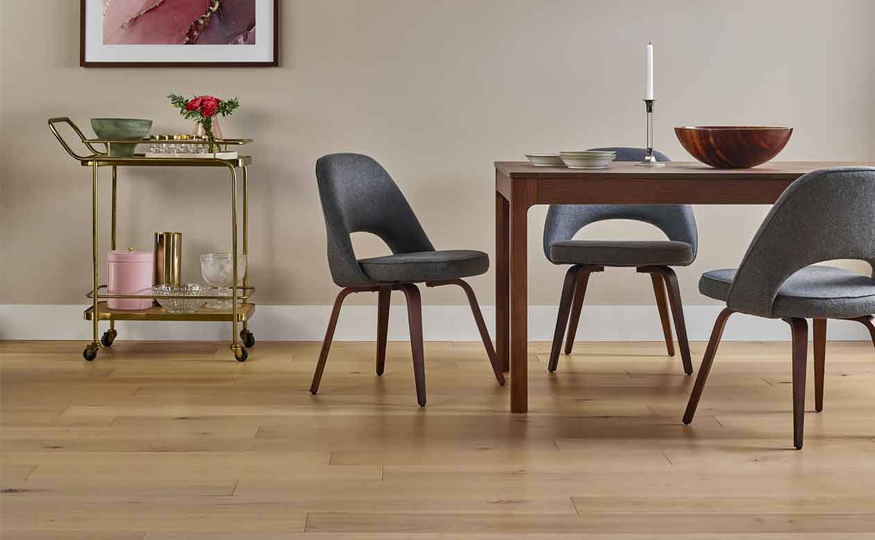 Light hardwood floor with kitchen seating, black chairs 