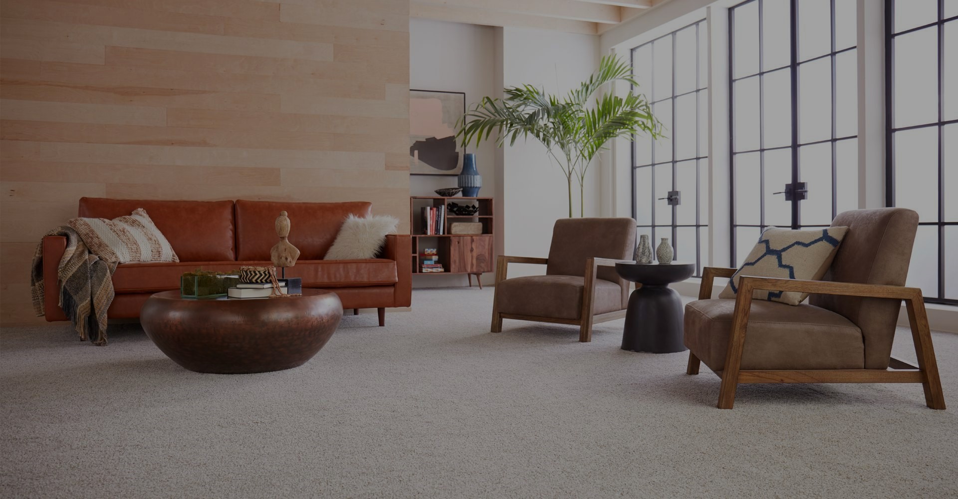 Woman sitting on a hardwood floor with a coffee mug in her hand.